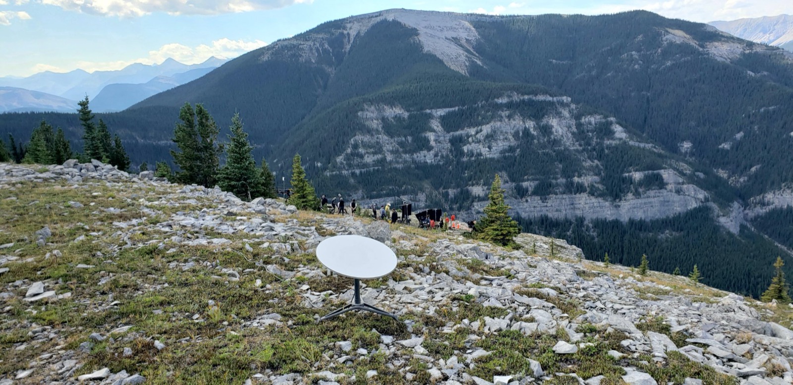 Starlink dish deployed on a Rocky Mountain summit with film crew